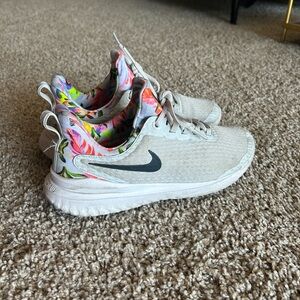 Nike running shoes all white with floral pattern on back